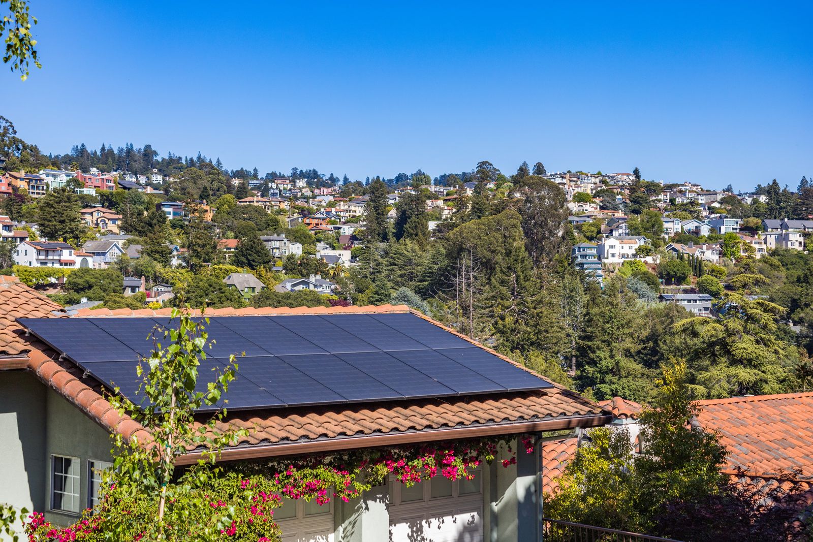 Suburban Texas home with rooftop solar panels under a sunny blue sky